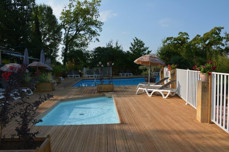 La plage en bois et les deux piscines extérieures chauffées